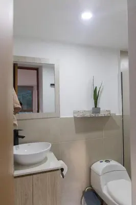 a bathroom with a sink and a toilet and a mirror at Espacio en Medellin, Ideal para tu estilo de vida moderno, estrátegico y cómodo in Medellín