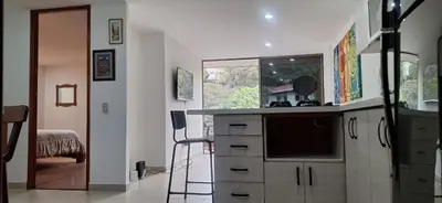 a kitchen with a counter top with a tv and a counter top at Espacio en Medellin, Ideal para tu estilo de vida moderno, estrátegico y cómodo in Medellín