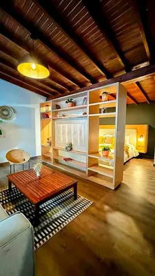 a living room with a coffee table and a bed at Suite con jacuzzi en El Poblado in Medellín