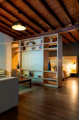 a living room with a bed and a table and a couch at Suite con jacuzzi en El Poblado in Medellín