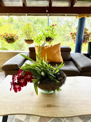 a table with a vase of flowers on it at House near Marial stone and old Peñol replica in Horizonte