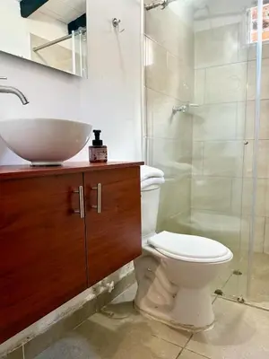 a bathroom with a sink and a toilet and a shower at House near Marial stone and old Peñol replica in Horizonte