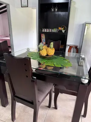 a glass table with a plate of fruit on it at House near Marial stone and old Peñol replica in Horizonte