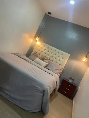 a bedroom with a large bed with a white headboard at cozy Apartamento de 1alcoba los molinos CERCA a laurles in Medellín