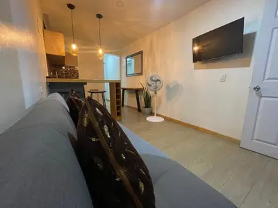 a living room with a couch and a kitchen at cozy Apartamento de 1alcoba los molinos CERCA a laurles in Medellín