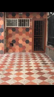 a building with a tiled floor and a door at cozy Apartamento de 1alcoba los molinos CERCA a laurles in Medellín