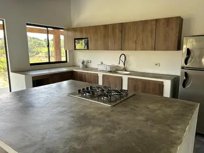 a kitchen with a stove and a counter top at Espectacular vista a la represa el peñol in La Pradera