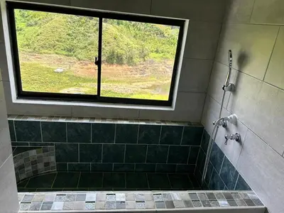 a bathroom with a shower with a window at Espectacular vista a la represa el peñol in La Pradera