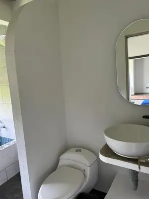 a bathroom with a toilet and a sink at Espectacular vista a la represa el peñol in La Pradera