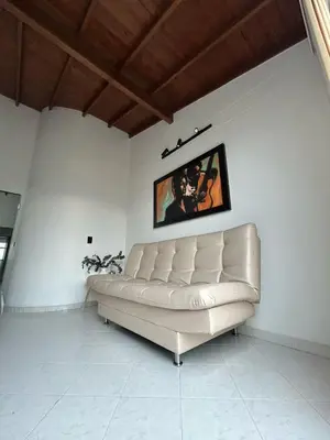 a white couch in a room with a picture on the wall at Hermoso apartamento para disfrutar su estadía in Medellín