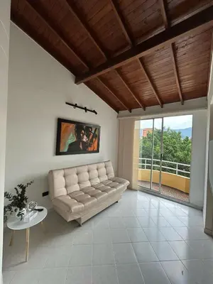 a living room with a couch and a table at Hermoso apartamento para disfrutar su estadía in Medellín
