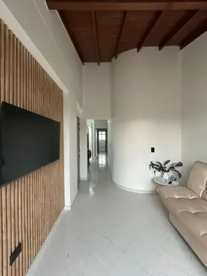 a living room with a couch and a tv on a wall at Hermoso apartamento para disfrutar su estadía in Medellín