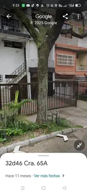 a tree in front of a fence next to a building at En el mejor punto de Medellin in Medellín