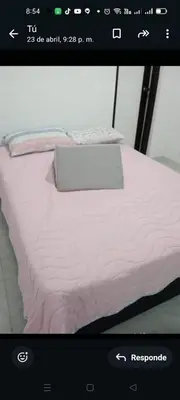 a laptop computer sitting on top of a bed at En el mejor punto de Medellin in Medellín