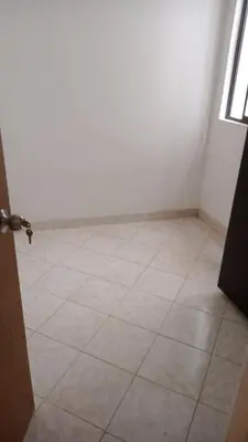 an empty room with a tile floor and a door at En el mejor punto de Medellin in Medellín