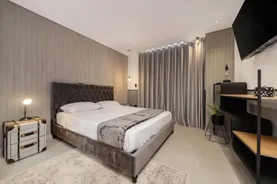 a bedroom with a large bed and a desk at Apt in el Poblado, walkable area with parking 215 in Medellín