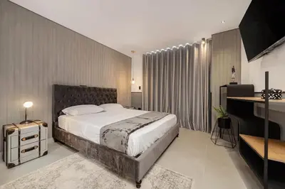 a bedroom with a large bed and a desk at Apt in el Poblado, walkable area with parking 215 in Medellín