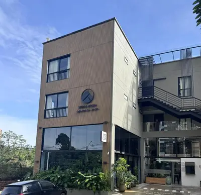 a building with a clock on the side of it at Apt in el Poblado, walkable area with parking 215 in Medellín