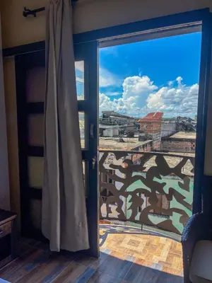a room with a window with a view of a city at Hotel Casa Madrid in Puerto Berrío