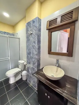 a bathroom with a sink and a toilet and a mirror at Hotel Casa Madrid in Puerto Berrío