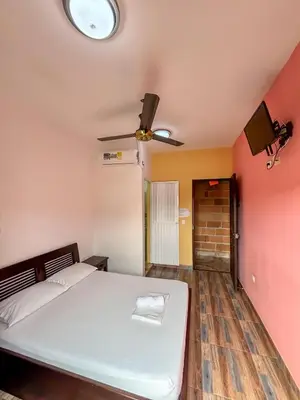 a bedroom with a bed and a ceiling fan at Hotel Casa Madrid in Puerto Berrío
