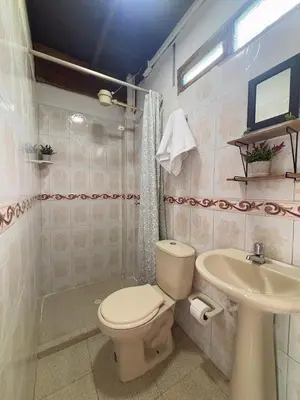 a bathroom with a toilet and a sink at Las Casas de Tomate in Guatapé