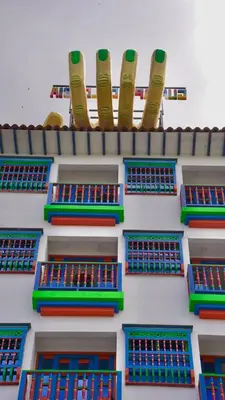 a building with colorful windows on the side of it at Las Casas de Tomate in Guatapé