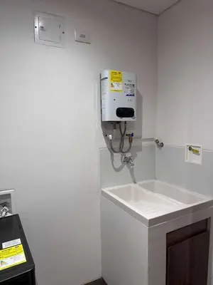 a bathroom with a sink and a soap dispenser on the wall at El Poblado, Medellin, Antioquia, Colombia in Medellín
