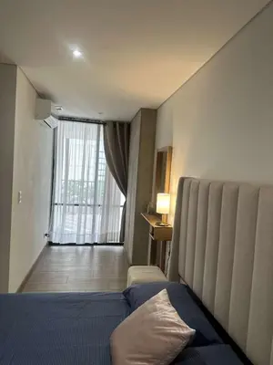 a hotel room with a bed and a large window at El Poblado, Medellin, Antioquia, Colombia in Medellín