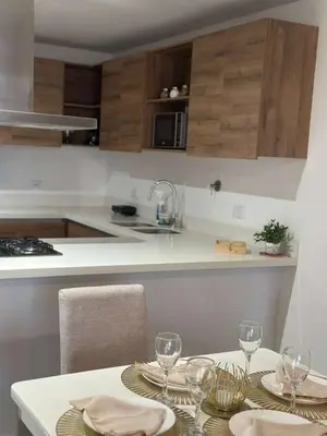 a kitchen with a table with wine glasses on it at El Poblado, Medellin, Antioquia, Colombia in Medellín