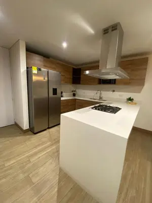 a kitchen with a white counter and a refrigerator at El Poblado, Medellin, Antioquia, Colombia in Medellín