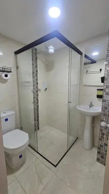 a bathroom with a shower and a toilet and a sink at Sensitivo Home in Envigado