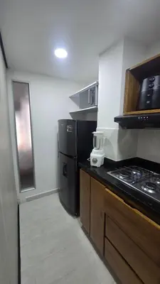 a kitchen with a stove and a refrigerator at Sensitivo Home in Envigado