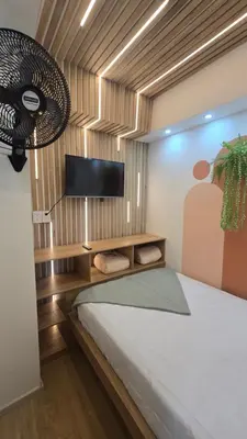 a bedroom with a bed and a flat screen tv at Sensitivo Home in Envigado
