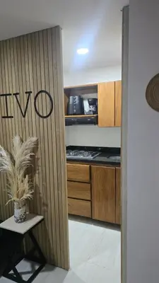 a kitchen with wooden cabinets and a potted plant at Sensitivo Home in Envigado