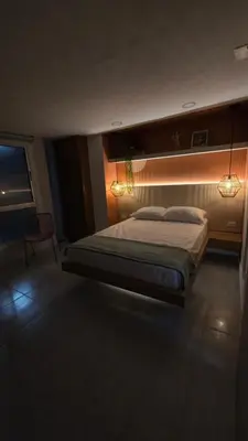 a bedroom with a bed with lights on it at Sensitivo Home in Envigado