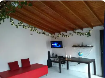 a living room with a red bench and a desk at Acogedora Habitación Privada - Belén Rosales Laureles in Medellín