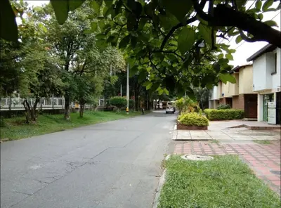 an empty street with trees and a building at Acogedora Habitación Privada - Belén Rosales Laureles in Medellín
