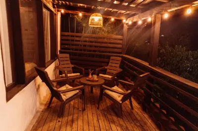 a patio with chairs and a table and a chandelier at Casa Samai Embera in Rionegro