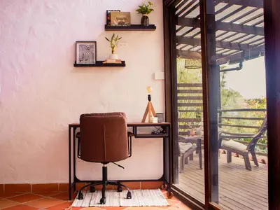 an office with a desk and a chair on a porch at Casa Samai Embera in Rionegro