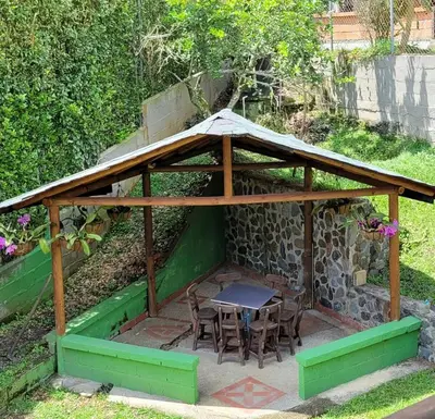 a wooden gazebo with a table and chairs at Cabaña en Copacabana Antioquia, cerca a Medellín in Copacabana