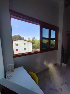 a room with a white table and a window at Refugio Chamahua in Jericó
