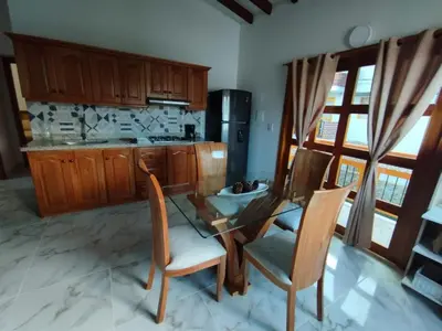 a kitchen with a glass table and chairs in it at Refugio Chamahua in Jericó