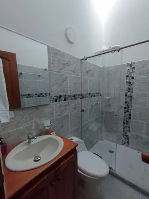 a bathroom with a sink and a toilet and a shower at Refugio Chamahua in Jericó