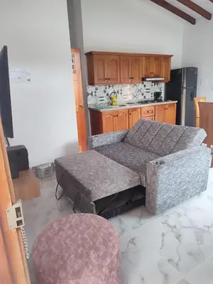 a kitchen with two stools and a table in a room at Refugio Chamahua in Jericó
