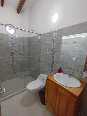 a bathroom with a toilet and a sink and a shower at Refugio Chamahua in Jericó