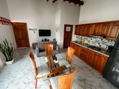a kitchen with a table with a cat sitting on it at Refugio Chamahua in Jericó
