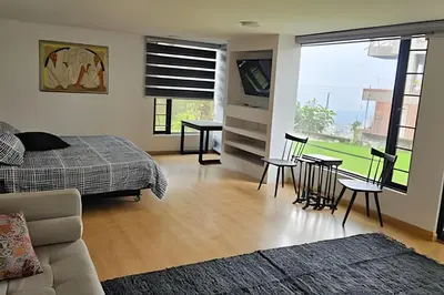a bedroom with a bed and a table and chairs at Casa Campestre, Ubicación Central in Manizales