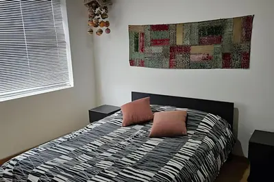 a bedroom with a bed with two pillows on it at Casa Campestre, Ubicación Central in Manizales