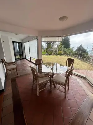 a dining room with a glass table and chairs at Casa Campestre, Ubicación Central in Manizales
